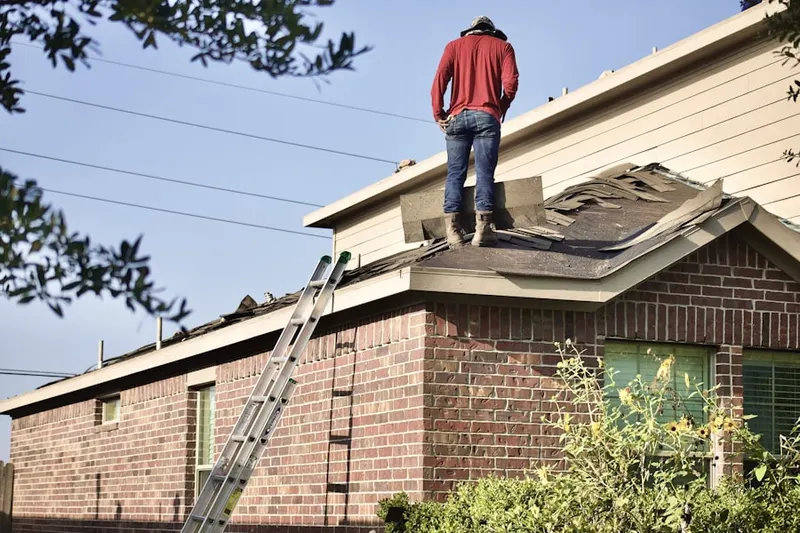 Professional roofer working on a residential roof in Omo Ranch